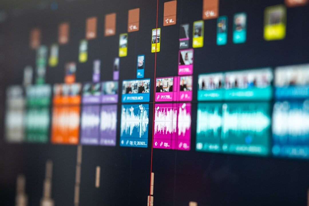 Sound engineer adjusting audio mixing console with waveform screens