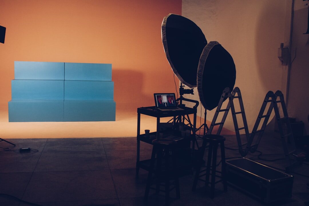 Studio lighting rig with softboxes above a television set
