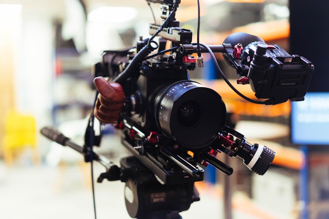 Television camera operator filming in a professional broadcast studio